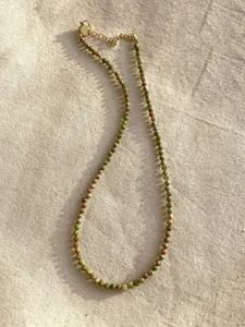 Detailed view of faceted natural unakite stone beads on a delicate choker necklace.