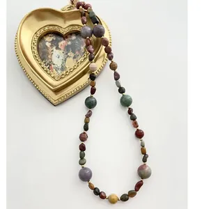 Close-up of irregular natural stone beads in oil painting colors with gold accents