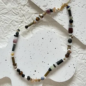 Detailed macro view of irregular colorful natural stone beads on a retro style necklace