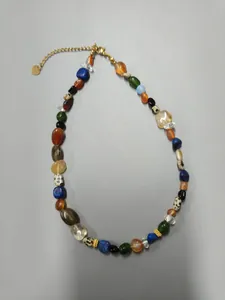 Detailed view of the colorful irregular natural stone necklace with vintage gold-tone clasp.