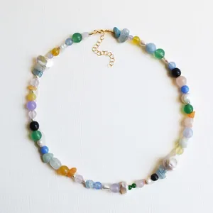 Vibrant vintage-style necklace featuring irregular natural stones and baroque pearls