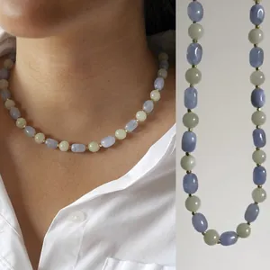Detailed view of handmade irregular natural stone necklace with vintage oil painting style.