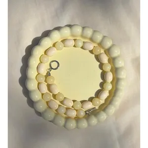 Close-up of irregular natural stone necklace with vintage oil painting style beads