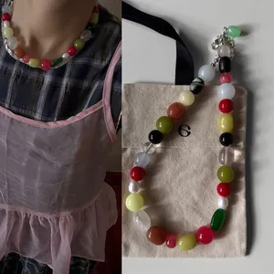 Close-up of a colorful irregular natural stone necklace with retro oil painting style.