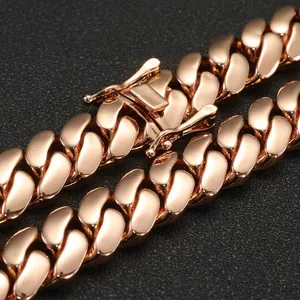 Macro detail of a rose gold Cuban link chain showing the polished clasp and smooth texture