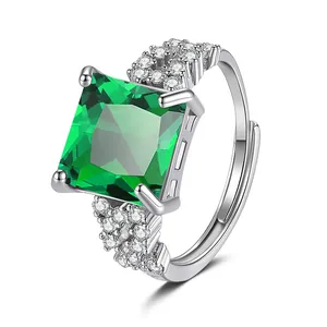 Detailed view of luxury square green gemstone and sparkling accent stones on silver ring
