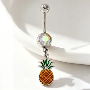 Detailed macro view of a silver belly ring with iridescent rhinestone and pineapple charm