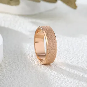 Detailed macro view of a rose gold matte frosted band ring with a textured finish.