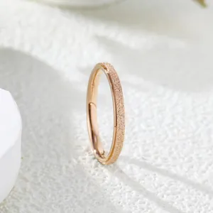 Detailed macro shot of a rose gold frosted ring featuring a minimalist plain band texture
