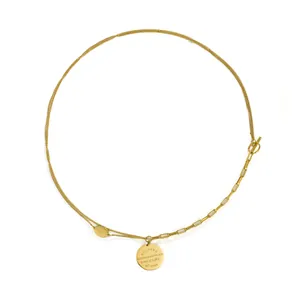 Detailed view of a gold double-layer necklace with engraved round plate and OT buckle