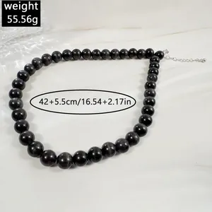 Close-up of bohemian beaded necklace with dark round beads, 42cm length and 55.56g weight