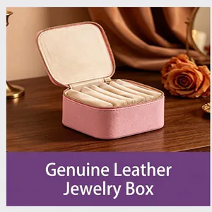 Close-up detail of a pink portable jewelry box showing soft velvet interior slots for rings
