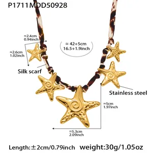 Detailed view of leopard print silk scarf necklace with golden starfish pendants.