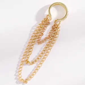 Detailed view of the gold-toned tassel chain ear cuff with sparkling rhinestone accents.