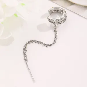 Detailed macro view of a silver crystal elf ear cuff with elegant long chain tassel