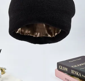 Detailansicht des glatten braunen Satinfutters in der schwarzen Strickmütze für den Winter
