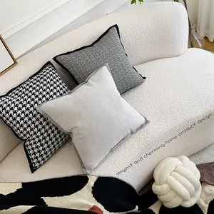 Cuscini decorativi in stile nordico in velluto e pied-de-poule su divano bianco