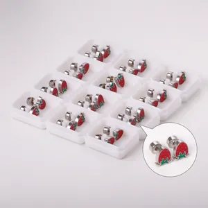 Detailed view of cute red strawberry shaped stainless steel stud earrings in white boxes