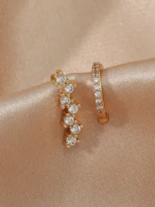 Detailed view of luxury gold-toned ear cuff and stud set with sparkling zirconia