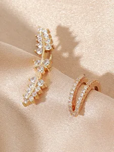 Detailed macro shot of gold flower leaf earring and pave cubic zirconia ear cuff set