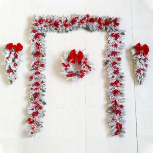 Elegant flocked Christmas wreath and garland set with red ornaments for festive home decor