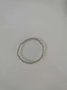 Minimalist silver-tone metallic bead stretch bracelet with smooth polished finish.