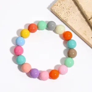 Close-up detail of vibrant multi-color bead elastic bracelet with smooth polished finish.