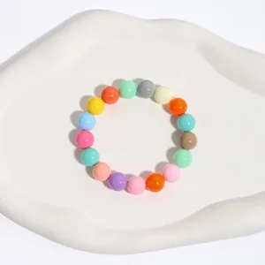 Macro detail of a colorful beaded stretch bracelet with smooth multi-color round beads