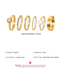Detailed view of 6 various gold alloy rings including faux pearls and rhinestones