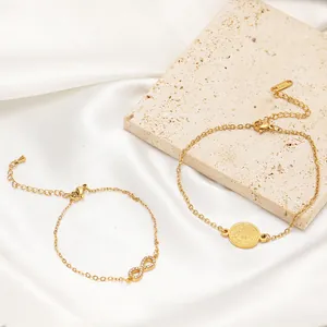 Detail view of gold-plated stainless steel DIY bracelets with infinity and coin charms