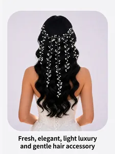 Back view of a bride wearing a delicate white pearl vine hair accessory on wavy black hair.