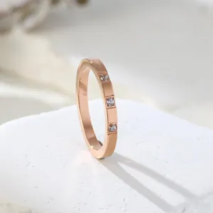Close-up detail of an elegant rose gold ring featuring three inlaid sparkling zircons