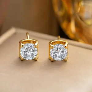 Elegant gold C-shape stud earrings with brilliant round sparkling gemstone detail