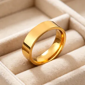 Close-up macro view of a 6mm polished gold stainless steel band ring in a velvet tray