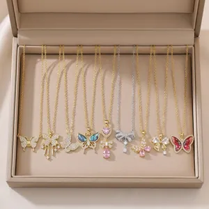 Collection of dainty butterfly and bow pendant necklaces in a jewelry display box