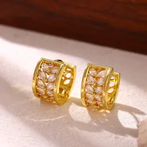 Detailed macro view of elegant gold hoop earrings with marquise-cut clear zircon stones