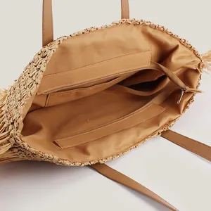 Woven straw tote bag featuring internal zipper pocket for women's seaside vacation style