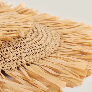 Detail of handmade straw woven bag with bohemian fringe tassels for summer beach vacation