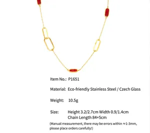 Close-up showing the red glass pendants and technical dimensions of the gold-toned necklace