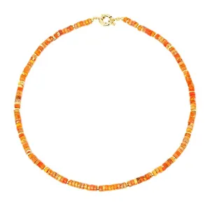 Close-up of vibrant orange natural semi-precious stone beaded necklace with gold clasp