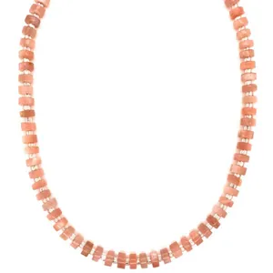 Macro view showing the natural texture of orange semi-precious stone beads on necklace