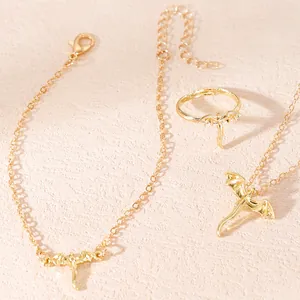 Close-up of a stylish golden dragon jewelry set featuring a necklace, ring, and bracelet.