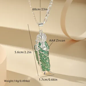 Detailed macro view of a St. Jude religious pendant with micro-set green zircons