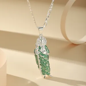 Detail of silver St. Jude pendant necklace with green cubic zirconia on 60cm Figaro chain.