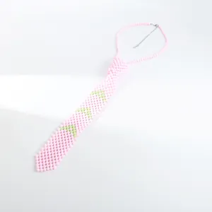Détail macro du collier cravate en perles roses fait main avec motifs d'étoiles vertes