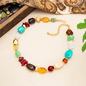 Detail view of Bohemian colorful resin bead necklace with irregular shapes and gold accents