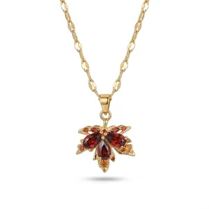 Elegant gold titanium steel necklace featuring a zircon-studded red maple leaf pendant