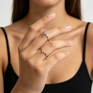 Close-up of minimalist rose gold and silver rings with zircon on model's hand