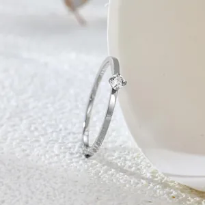 Close-up of a minimalist silver-tone titanium steel ring with a sparkling cubic zirconia