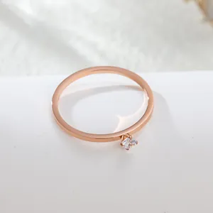 Close-up of a elegant rose gold titanium steel ring with a sparkling zircon